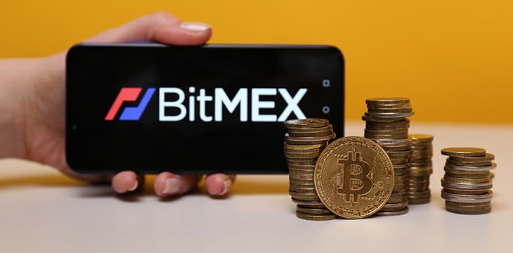 BitMex logo on the phone display.