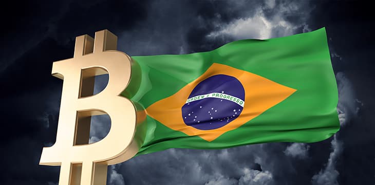 Gold bitcoin cryptocurrency with a waving Brazil flag.