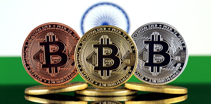 Physical version of Bitcoin (BTC) and India Flag.