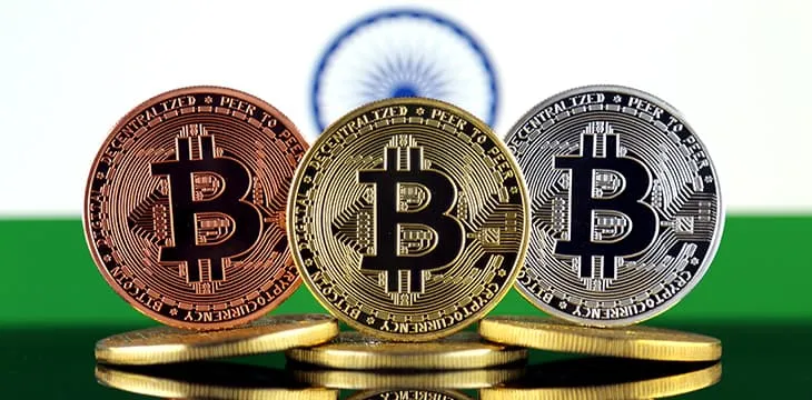 Physical version of Bitcoin (BTC) and India Flag.