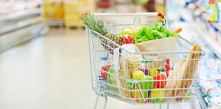 Shopping cart with different food inside.