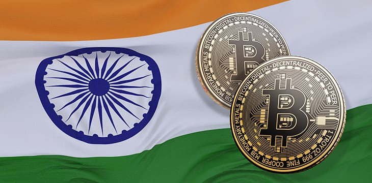3d rendering of two bitcoins in front of a Indian flag.