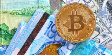 Kazakh tenge money and cryptocurrency Bitcoin close-up. Digital virtual internet currency investment concept