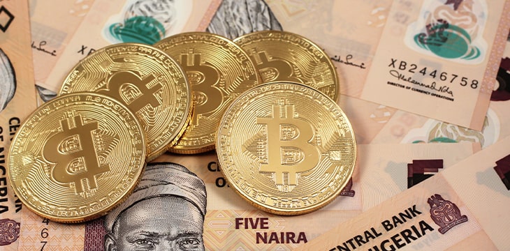 A close up image of golden bitcoins close up with Nigerian naira notes