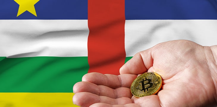 Golden bitcoin coin in man's hand