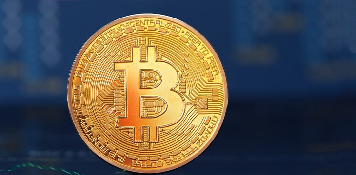 Bitcoin coin on dark blue background