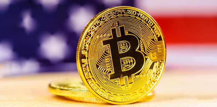 Golden Bitcoin coin on a table.