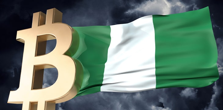 Gold bitcoin cryptocurrency with a waving Nigerian flag
