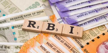 RBI on wooden cubes with Indian banknote