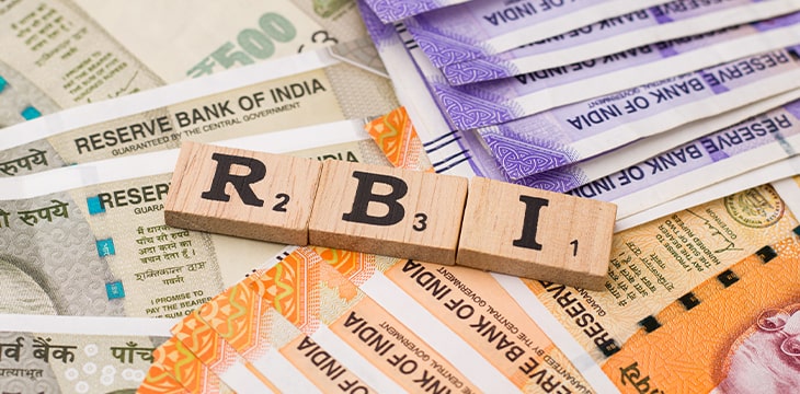 RBI on wooden cubes with Indian banknote