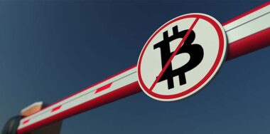 Barrier gate with Bitcoin prohibition sign