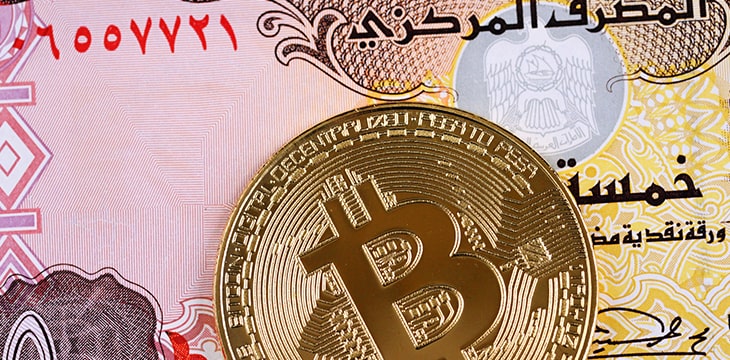 A United Arab Emirates five dirham note with Bitcoin coin