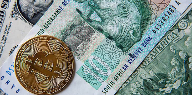 Bitcoin on South African rand and American dollar bills