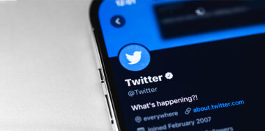 Twitter official verified account, mobile app on screen smartphone