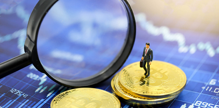 Miniature people Businessman with Magnifying glass of bitcoin graph chart ,bitcoin Stock Market Analysis