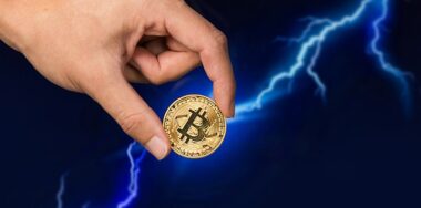 Bitcoin coin in front of lightning
