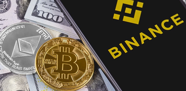 Apple iPhone and Binance logo and bitcoin