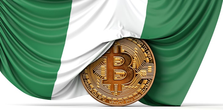 Nigeria flag draped over a bitcoin cryptocurrency coin