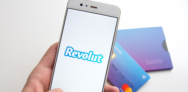 Phone with Revolut text over some credit cards