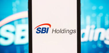 Smartphone with SBI holdings logo on the screen