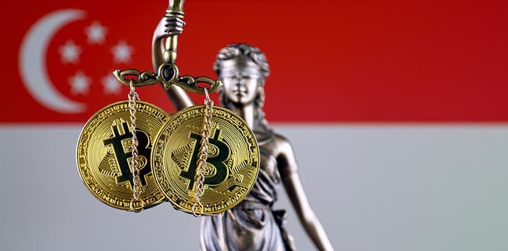 Symbol of law and justice, physical version of Bitcoin and Singapore Flag.