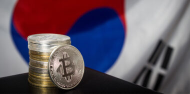 Stack of bitcoins over flag of South Korea