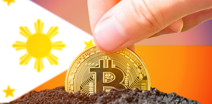 Legalization of bitcoins in the Philippines. Landing bitcoin in the ground on the background of the flag of the Philippines.