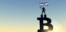 Person waving a israel flag standing on top of a Bitcoin sign