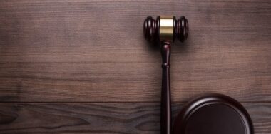 Judge gavel on brown wooden background
