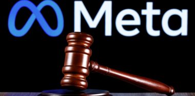 Gavel on table against the background of Meta company logo
