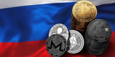 Stack of Bitcoin coins on Russian flag