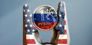 Pliers with USA flag squeezed the ruble with Russian flag