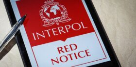 Interpol Red Notice displayed on mobile phone screen