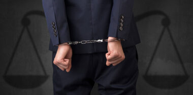 Handcuffed man with justice scale on background