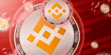 Binance Coin crash; Binance coins in a bubbles on the binary code background. Close-up — Photo