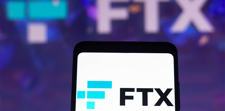 FTX Crypto Derivatives Exchange logo is displayed on a smartphone screen and in the background