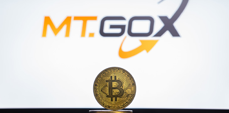 MtGox logo on a computer screen with a stack of Bitcoins