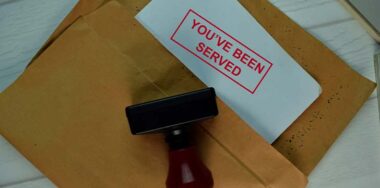 Red Handle Rubber Stamper and You've Been Served text isolated on the table. — Photo