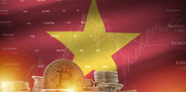 Vietnam flag and big amount of golden bitcoin coins