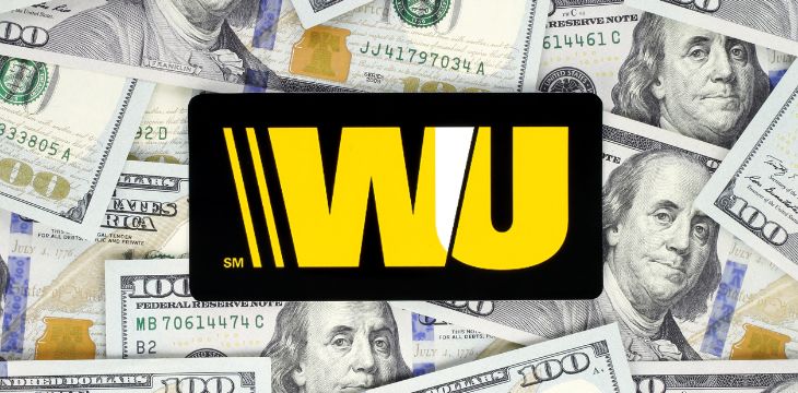 Western Union logo printed on paper, cut and placed on money background