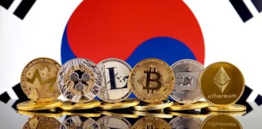 Bitcoin and other crypo coins in front of the flag of South Korea