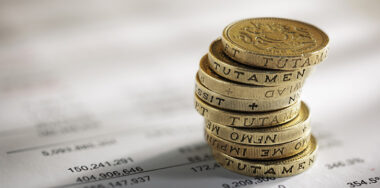 Stack of pound coins on financial figures