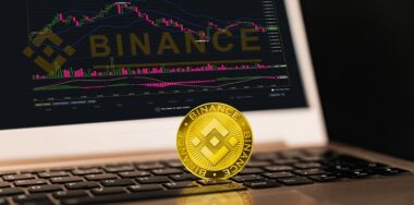 Binance Cryptocurrency in front of laptop