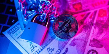 Bitcoin with chain and padlock on dollar cash