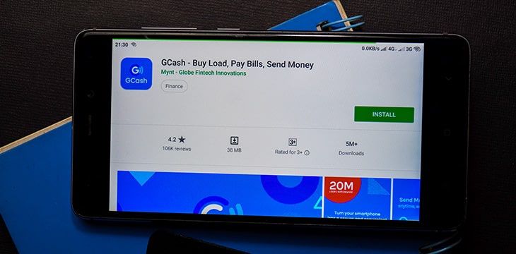 GCash - Buy Load, Pay Bills, Send Money dev app with magnifying on Smartphone screen