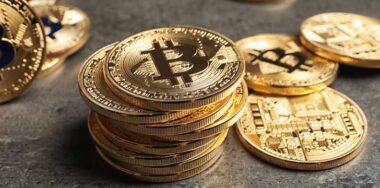 Golden bitcoins on grey background