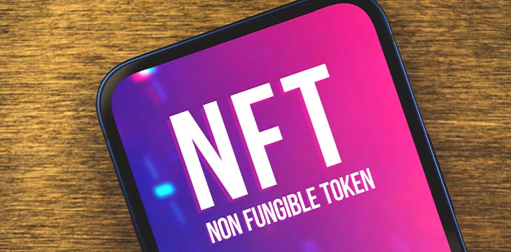 Cryptoart and technology, close-up of NFT non fungible token logo on the screen, blockchain and cryptocurrency concept, wooden background and top view — Photo
