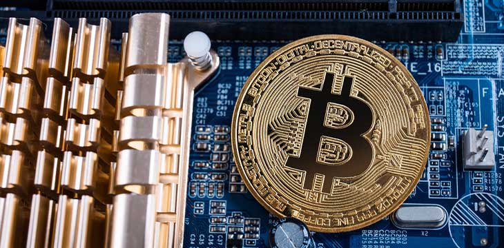 Gold bitcoin with microcircuits on a blue background