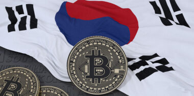 3d rendering of a metallic Bitcoin over South Korean flag