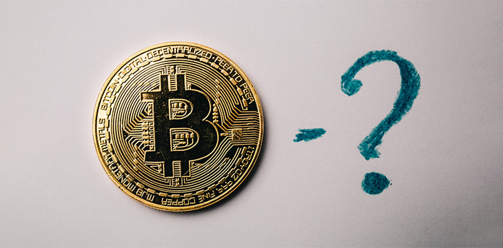 Bitcoin coin and question mark at white background, toned